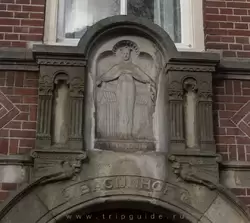 Святая Урсула — покровительница бегинок над входом в Бегинхоф в Амстердаме